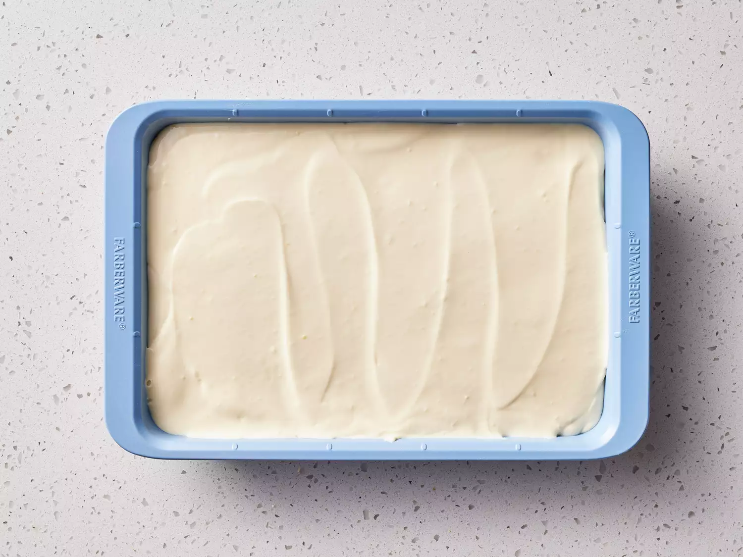 A rectangular baking dish topped with vanilla pudding