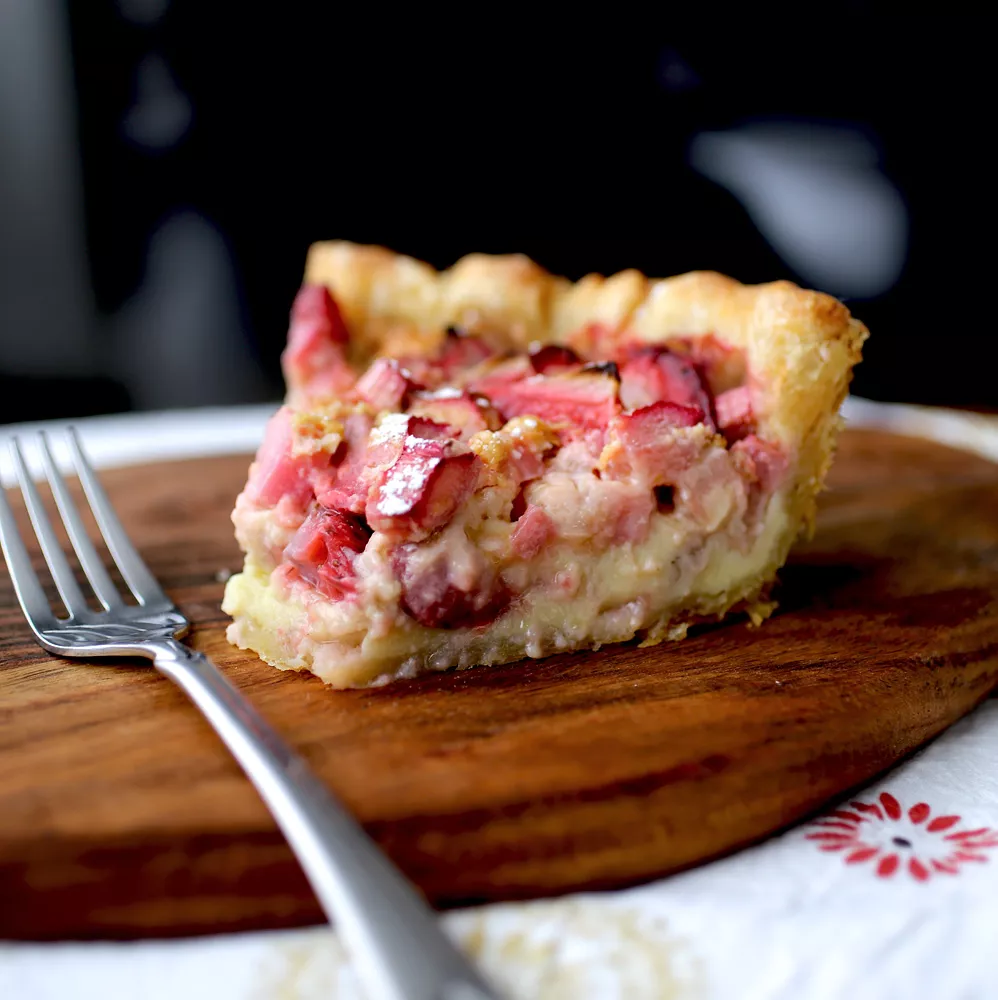 rhubarb pie slice on a wooden board